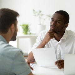 serious-attentive-african-hr-listening-to-candidate-at-job-interview-picture-id916520080-min